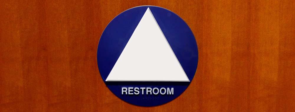 Gender inclusive restroom sign on door.