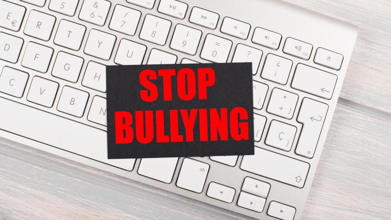 image of keyboard with text atop, reading Stop Bullying