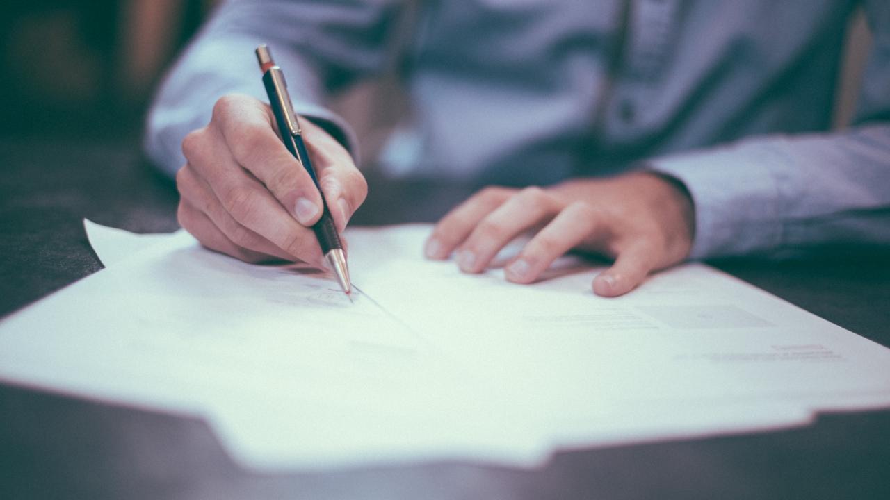 man writing in a notebook