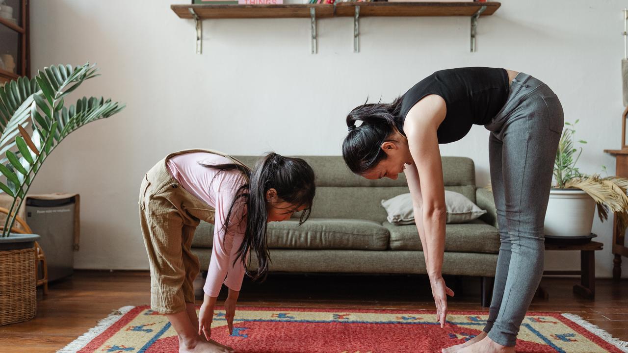 woman and her daughter stretching together