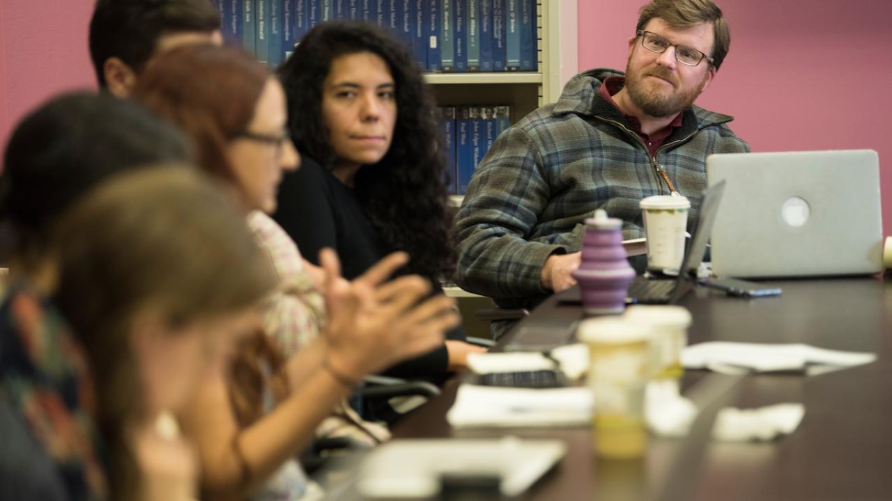 Group of people sitting in on a meeting.