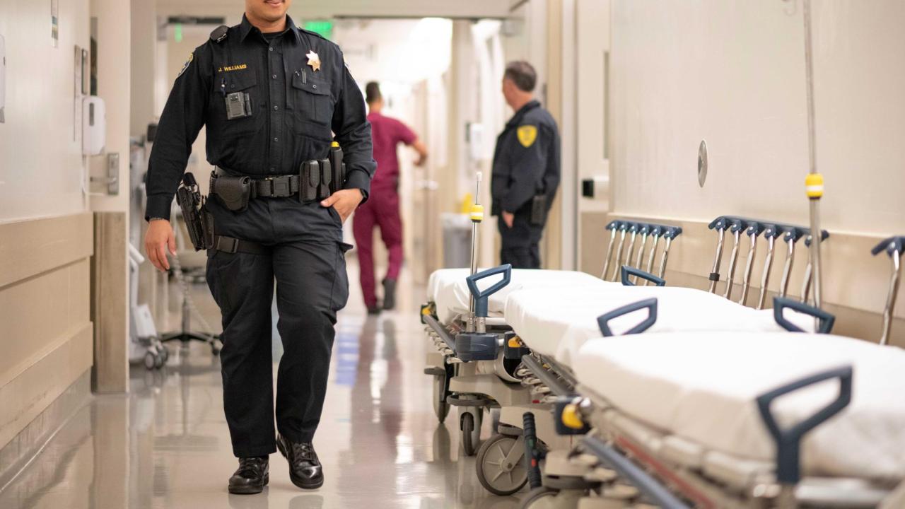 Police officer walking down the hospital hallway.