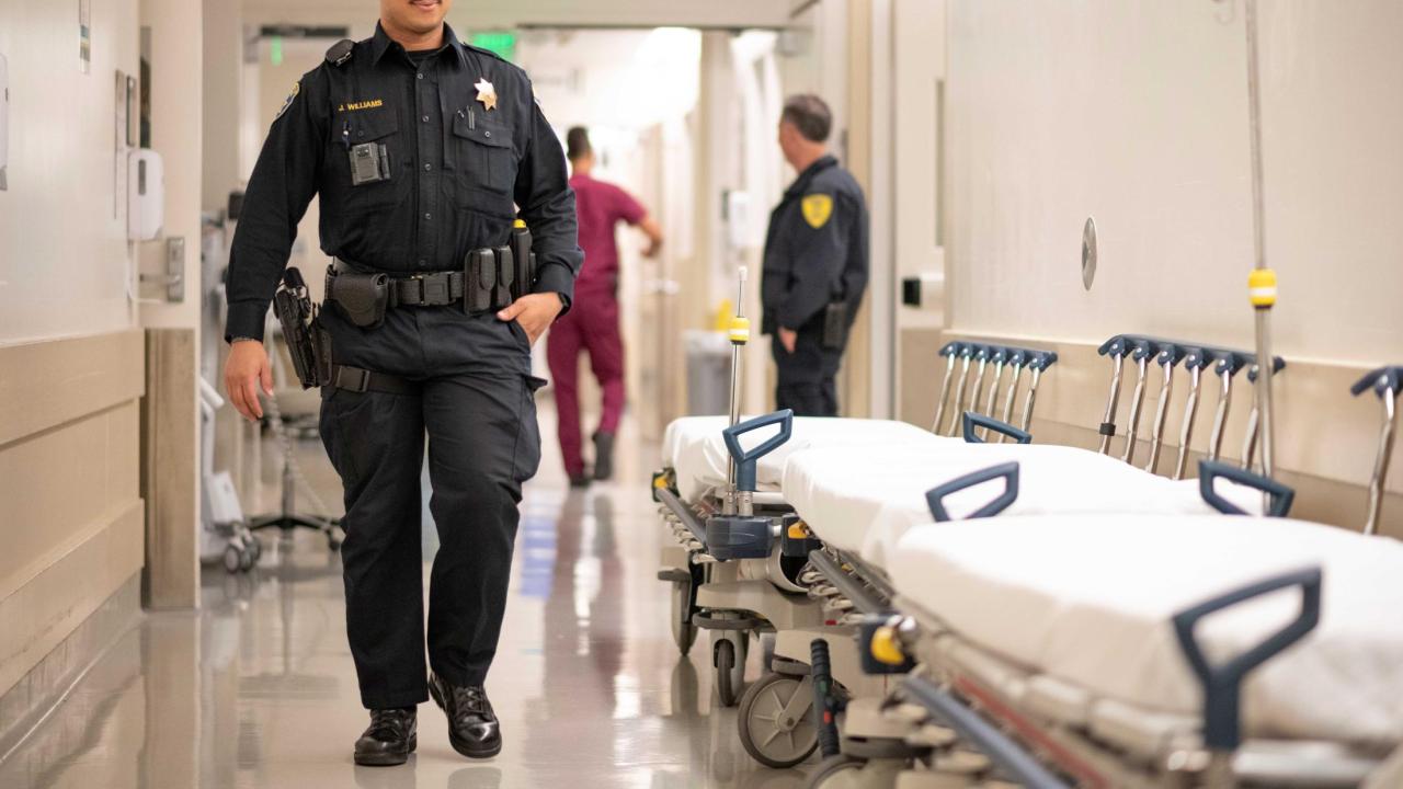 Police officer walking down the hospital hallway.  