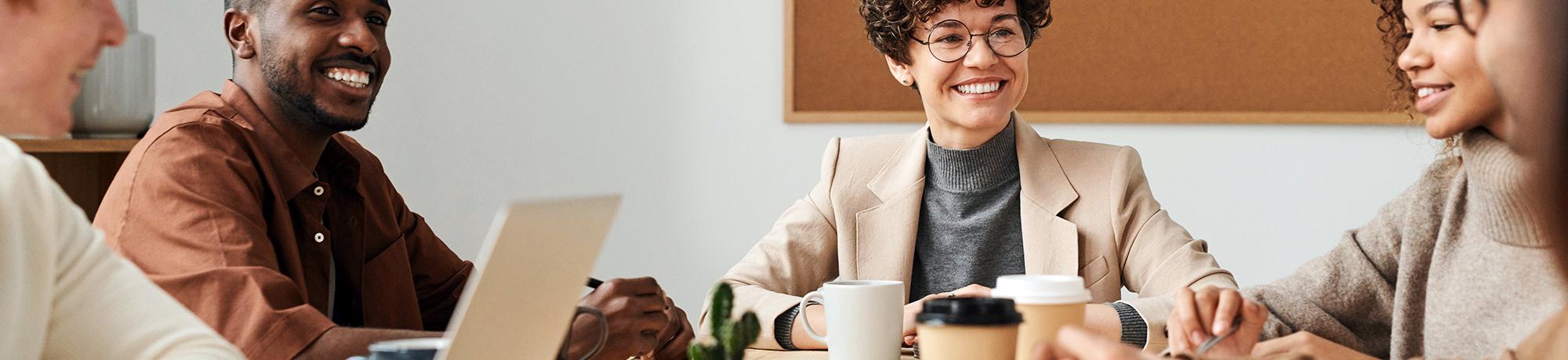 Decorative photo of coworkers at a conference table.